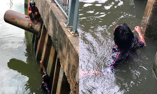 Người dân thòng dây xuống để cứu người đàn ông.