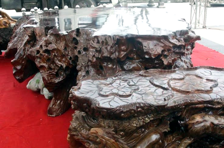 Cân đối hài hòa với chiếc “ghế vua” là chiếc bàn hình ô-van được trạm trổ rất kỳ công.