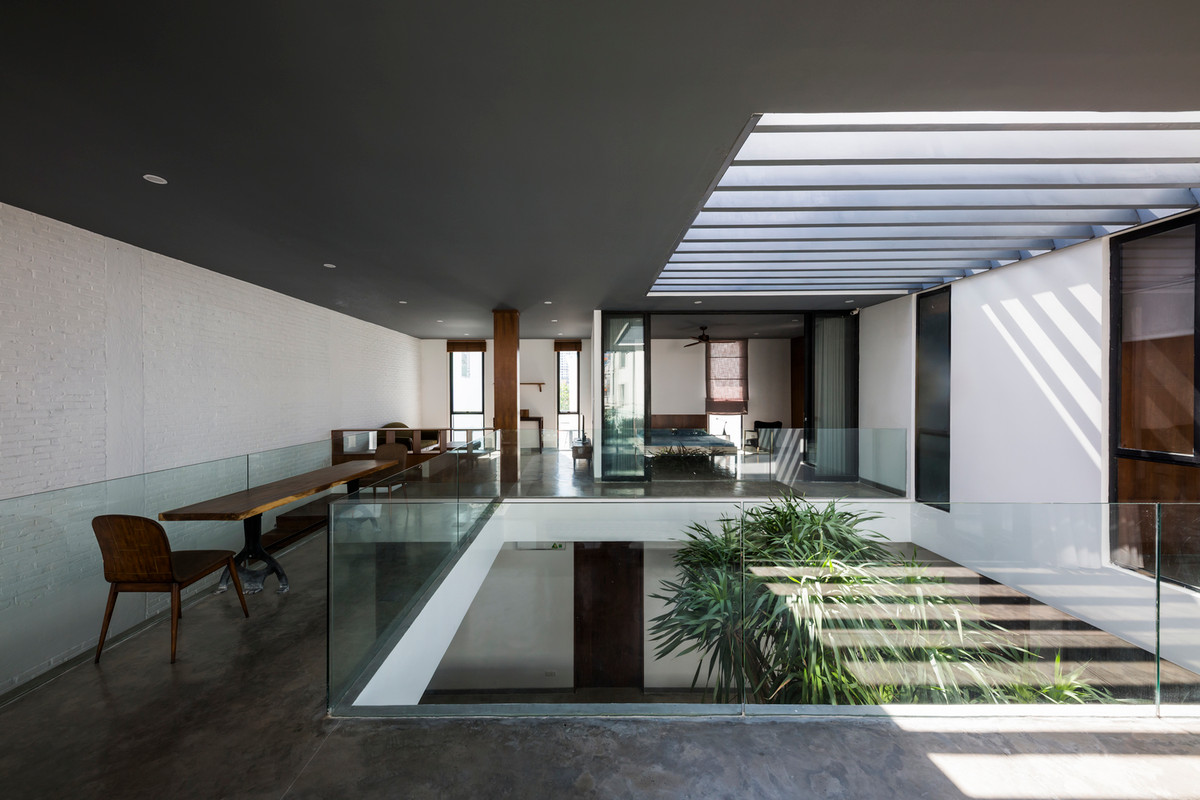 Giếng trời rộng sử dụng lan can kính sang trọng.