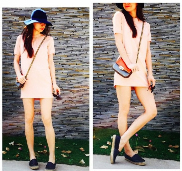 Dạo phố với váy suông màu hồng pastel, Hà Hồ đã lựa chọn cho mình phụ kiện là chiếc túi của Valentino làm điểm nhấn.