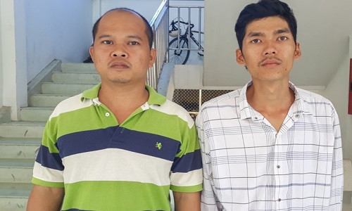 Vương (trái) và phát tại cơ quan điều tra.