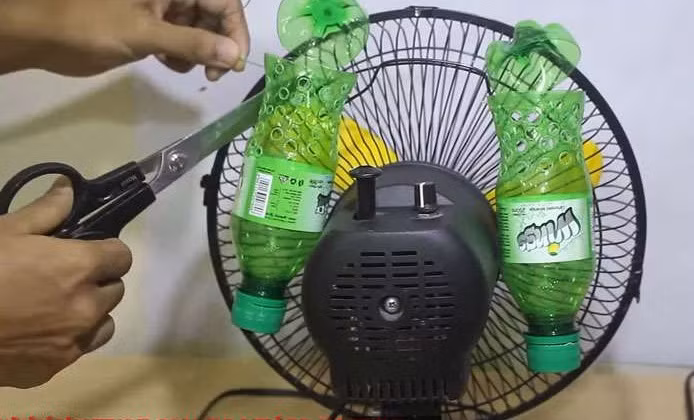 Gắn 2 chai nhựa vào quạt, bạn hoàn toàn có thể tự chế chiếc điều hòa giúp giảm nhiệt độ trong phòng. Ảnh: Youtube.