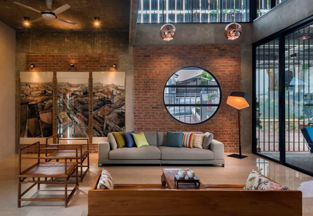 Bộ sofa và đèn đứng hiện đại nổi bật trên nền không gian mộc mạc.