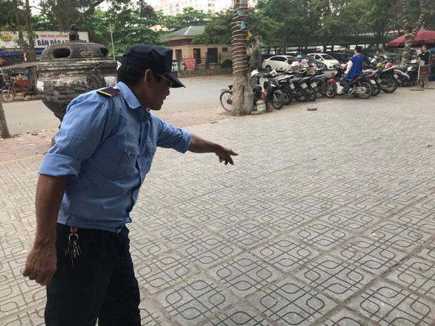 Một người bảo vệ chỉ nơi con rắn rơi xuống đất.