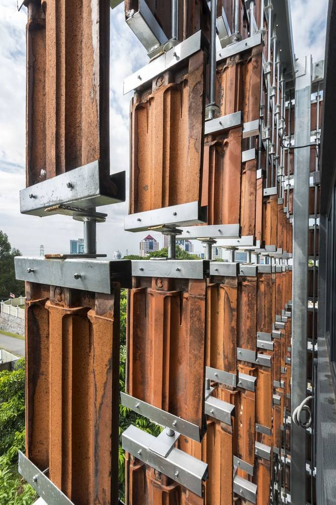 Các thanh thép dọc và khung giữ giúp liên kết các tấm ngói với nhau tương tự kết cấu của một tấm rèm.