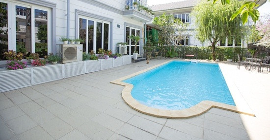 Sau nhà là khoảng sân rộng đi mãi không hết. Giữa sân là một bể bơi xanh mát. Ảnh: Vietnamnet.