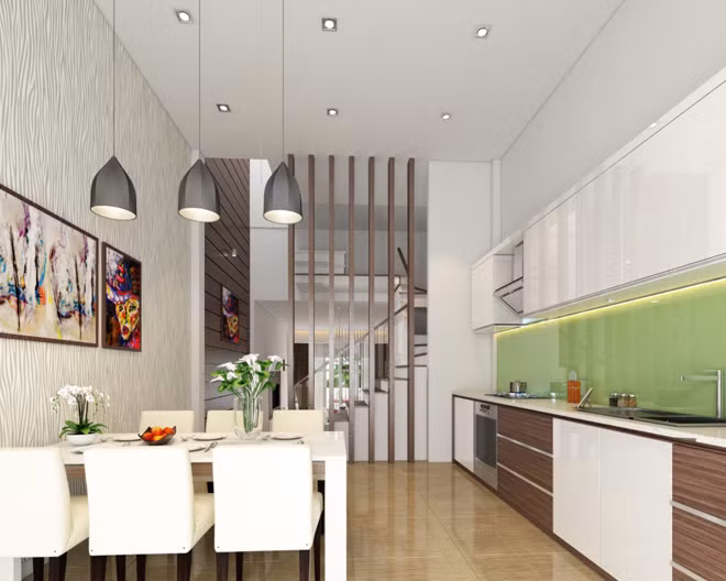 Dù diện tích chật hẹp nhưng nhờ màu trắng chủ đạo, điểm thêm tranh treo tường và đèn trần trang trí, không gian phòng bếp vẫn rộng rãi và thoáng đãng hơn.