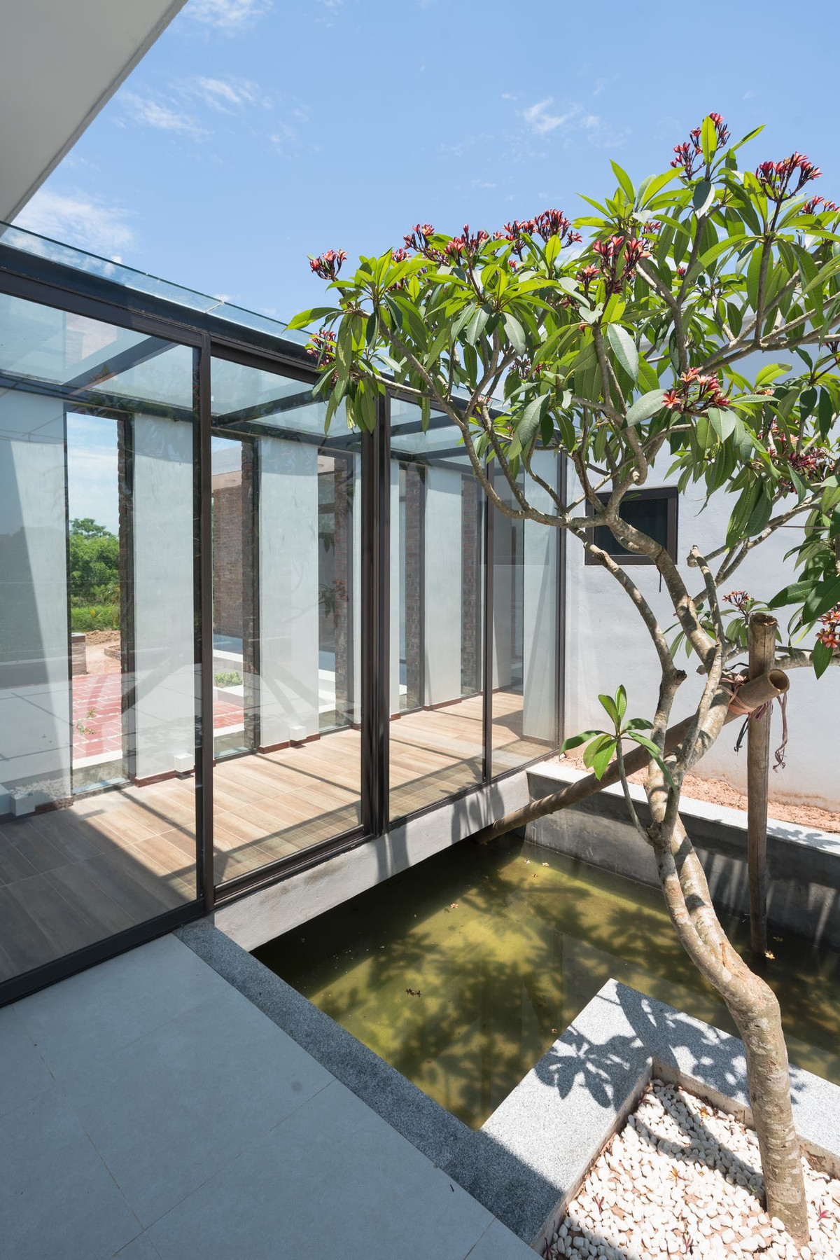 Hai khối nhà nối với nhau bằng hành lang bố trí nổi trên mặt nước.