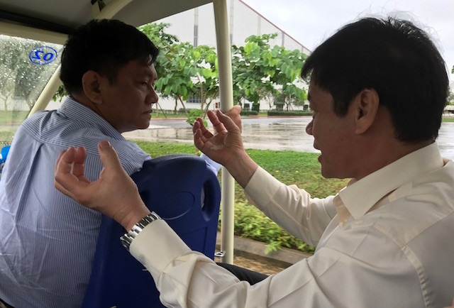 Tỷ phú Trần Bá Dương (phải) - Chủ tịch Thaco - say sưa bàn việc trên đường đi thăm các phân xưởng. Ảnh: Baodautu.