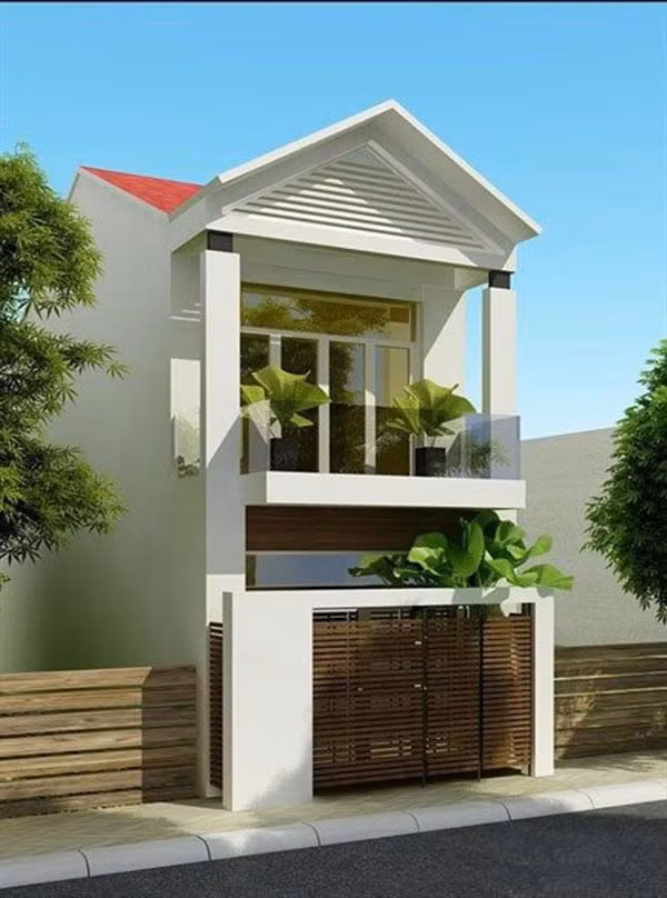 Nhà phố mái thái hiện đại có ban công và góc sân nhỏ trước nhà tạo cảm giác thoáng đãng. Ảnh: Ktshanoi.