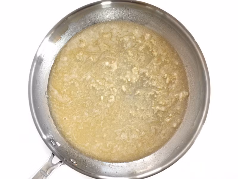 Để làm nước sốt mì Ý, cho tỏi băm nhỏ và cho vào chảo phi thơm với 2 thìa bơ khác, cho thêm một ít nước của hải sản đã xào qua ở trên vào phi khoảng 1-2 phút 