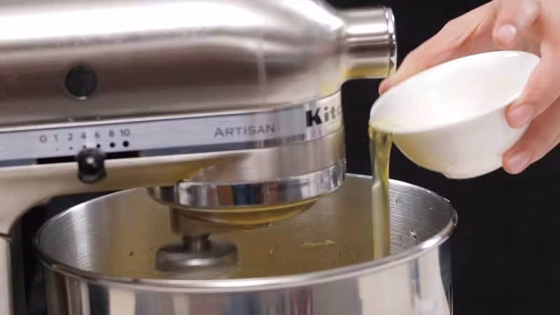 Cho lòng trắng trứng vào bát trộn rồi dùng máy đánh đều.