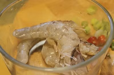 Rửa sạch tất cả các nguyên liệu, tôm cắt râu lột vỏ rồi bỏ chỉ lưng nếu có, rau muống cắt khúc dài khoảng 7cm, cà chua bổ múi cau, me cạo vỏ. 