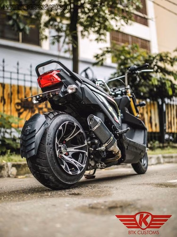 Để khiến chiếc Zoomer X có dáng "trường" và hầm hố hơn, MTK đã kéo dài gắp sau ra thêm 12 cm đồng thời lắp cho xe mâm nhôm bản lớn từ xe địa hình 4 bánh ATV. Đi kèm bộ mâm là chiếc lốp bản nhỏ hơn, khiến cho bánh xe có vẻ "mông to" độc đáo.