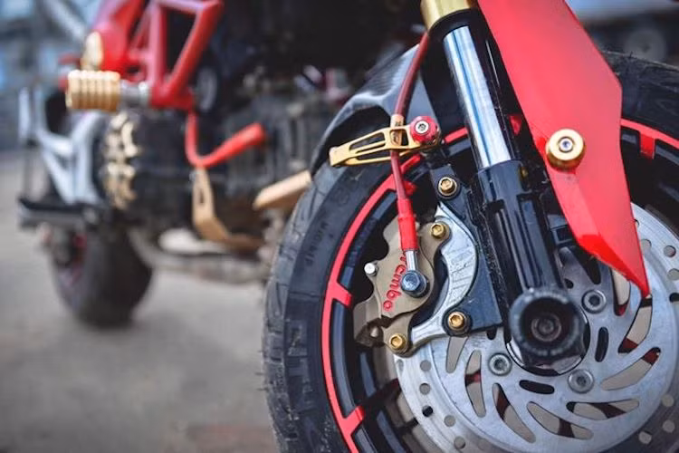 "Dàn chân" của chiếc MSX cũng đã được độ lại với cặp mâm Kuni nhiều nan có thiết kế độc đáo với 2 tông màu đỏ/đen giống với chiếc xe. Hệ thống phanh trước vẫn giữ nguyên đĩa "zin" từ MSX, nhưng có heo được độ lên loại Brembo Billet 2 pis đối xứng "hàng hiệu".