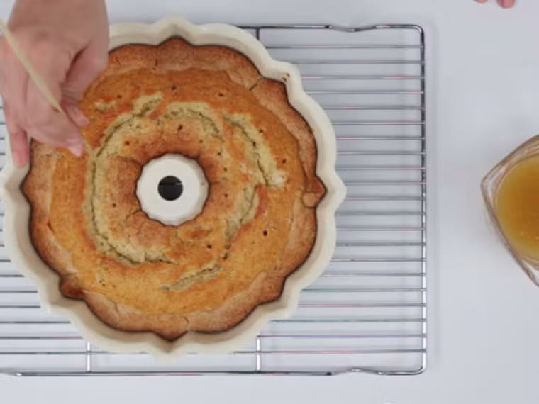 Lấy bánh ra khỏi lò, dùng vật nhọn tạo các lỗ nhỏ trên bề mặt bánh rồi đổ siro lên. Cứ để yên như vậy chừng 45 phút là được.