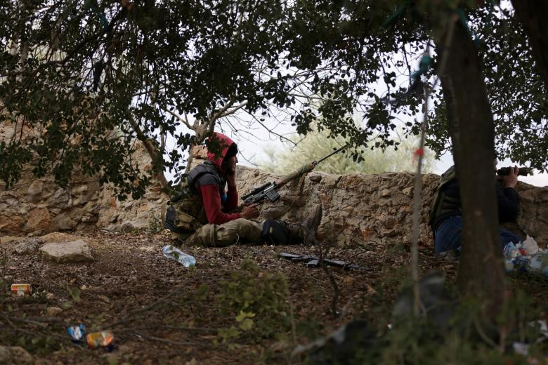 Một tay súng FSA nói chuyện điện thoại khi đang cầm súng chiến đấu ở Afrin ngày 16/2.