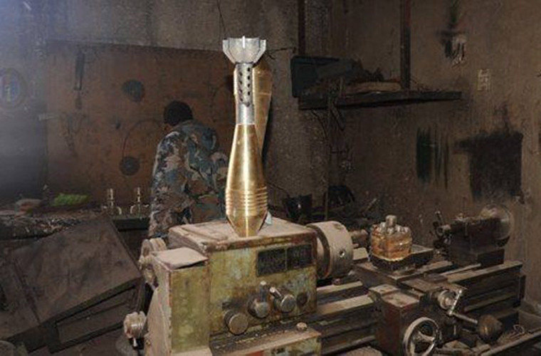 Một binh sĩ Syria kiểm tra bên trong nhà máy sản xuất tên lửa sau khi giành quyền kiểm soát địa điểm này. Ảnh: FNA.