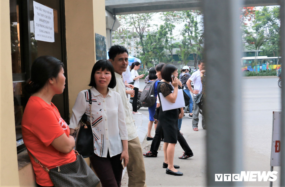 Đúng 8h, các em bắt đầu làm bài thi. Bên ngoài, các phụ huynh thấp thỏm, đứng ngồi không yên.