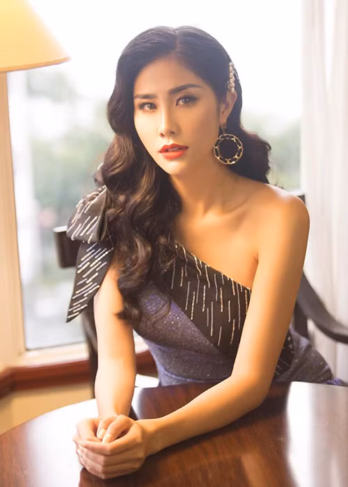 Hoàng Hạnh mạnh dạn thử tông make up sắc sảo, mái tóc uốn xoăn nhẹ bồng bềnh và mặc chiếc váy lệch vai gợi cảm.