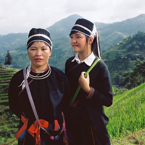 Hai mẹ con người Dao Áo dài trước những khu ruộng bậc thang kỳ vĩ.