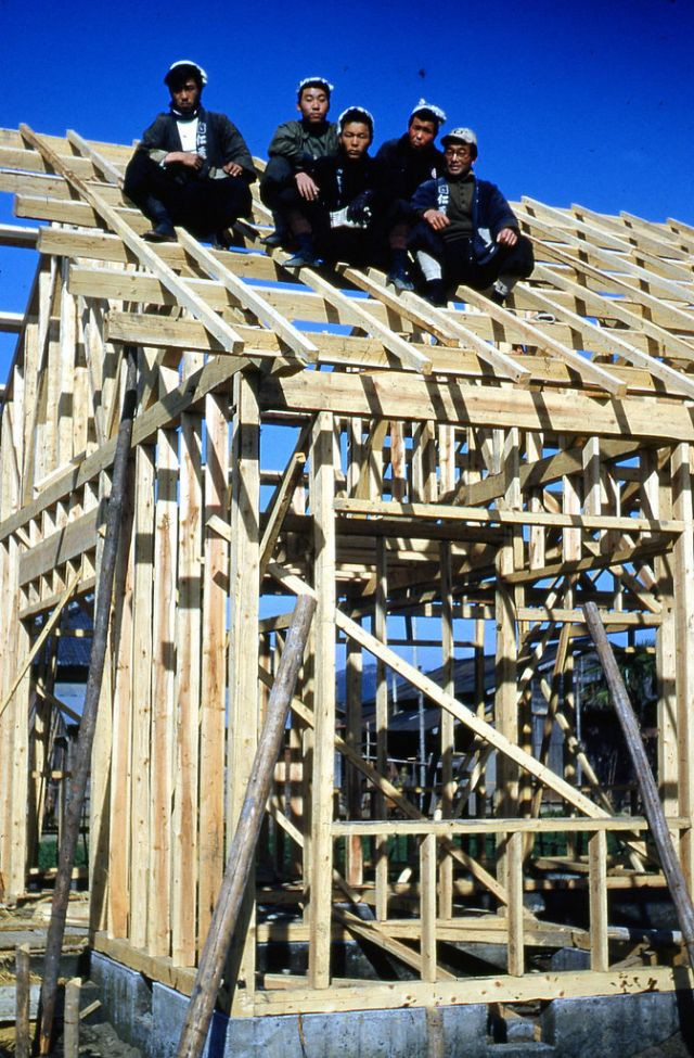 Những người thợ thi công xây dựng một ngôi nhà bằng gỗ.