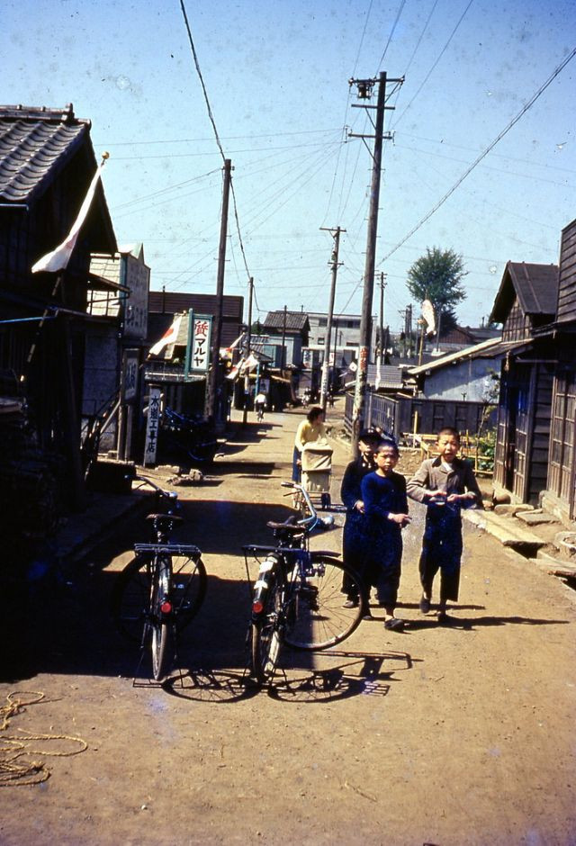 Những cậu bé người Nhật Bản chơi đùa trên một con phố nhỏ.