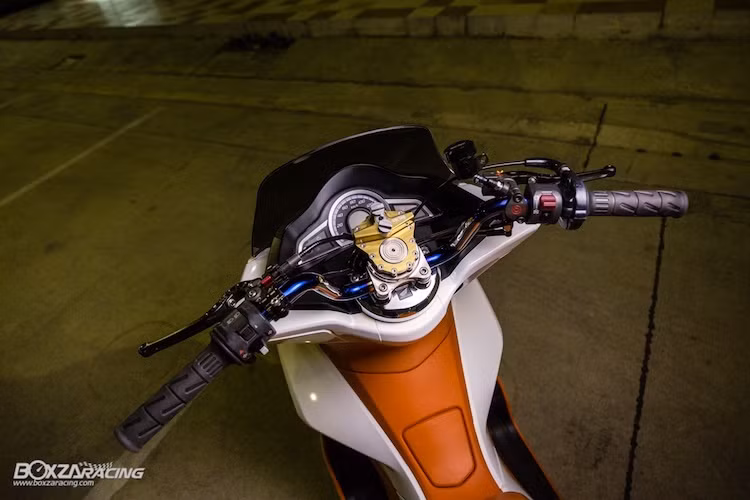 Ở phía trên tay lái, ghi-đông nguyên bản của PCX đã được thay bằng tay lái kiểng được gia nhiệt để có ánh xanh như titan.Nằm chính giữa tay lái là cây trợ lực trung tâm Ohlins, trong khi ở phía bên tay trái có sự xuất hiện của cùm phanh dây CRG.