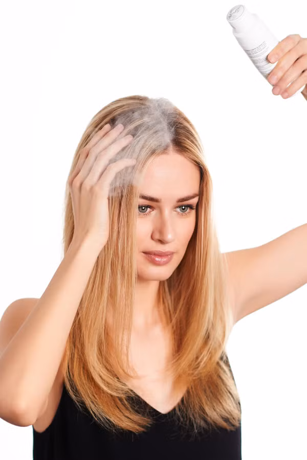 Dùng dầu gội khô. Nếu như tóc bẩn và bết lại với nhau thì vết chân đen sẽ càng bị lộ. Hãy dùng dầu gội khô xịt vào phần đỉnh và chân tóc để nó làm tơi tóc và dễ dàng khiến cho các sợi tóc đi đúng hướng. Khi đó bạn sẽ dễ dàng tạo kiểu tóc hơn và mái tóc sẽ không lộ màu đen quá.