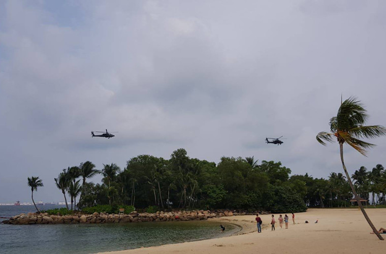 Việc điều động cả trực thăng tấn công hạng nặng được xếp hàng top trên thế giới cho thấy an ninh Singapore tập trung tới mức nào cho cuộc gặp gỡ lịch sử của hai nhà lãnh đạo Mỹ - Triều Tiên. Trong ảnh, biên đội AH-64D Apache bay dọc bờ biển Singapore ở độ cao thấp, dường như họ đang thực hiện nhiệm vụ bay tuần tra. Nguồn ảnh: Strait Times