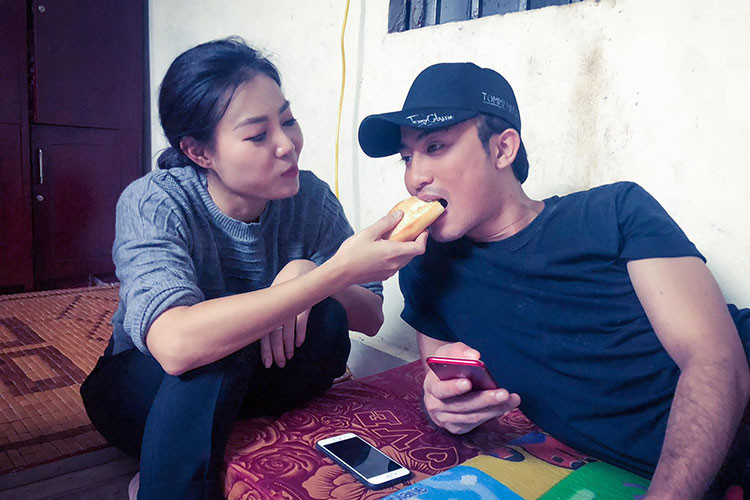 Khoảnh khắc Thanh Hương chia sẻ chiếc bánh mì với Doãn Quốc Đam ở hậu trường phim.