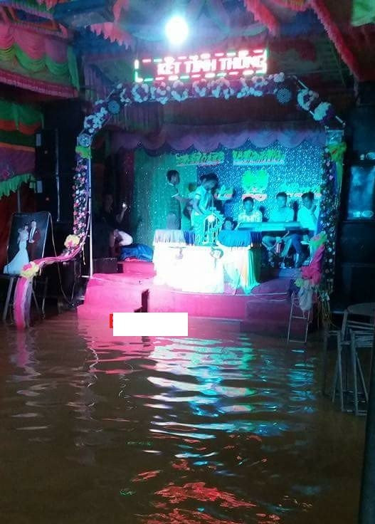 Dù nước ngập đến sàn sân khấu nhưn đám cưới ở Hưng Yên vẫn diễn ra với đầy đủ nghi thức.