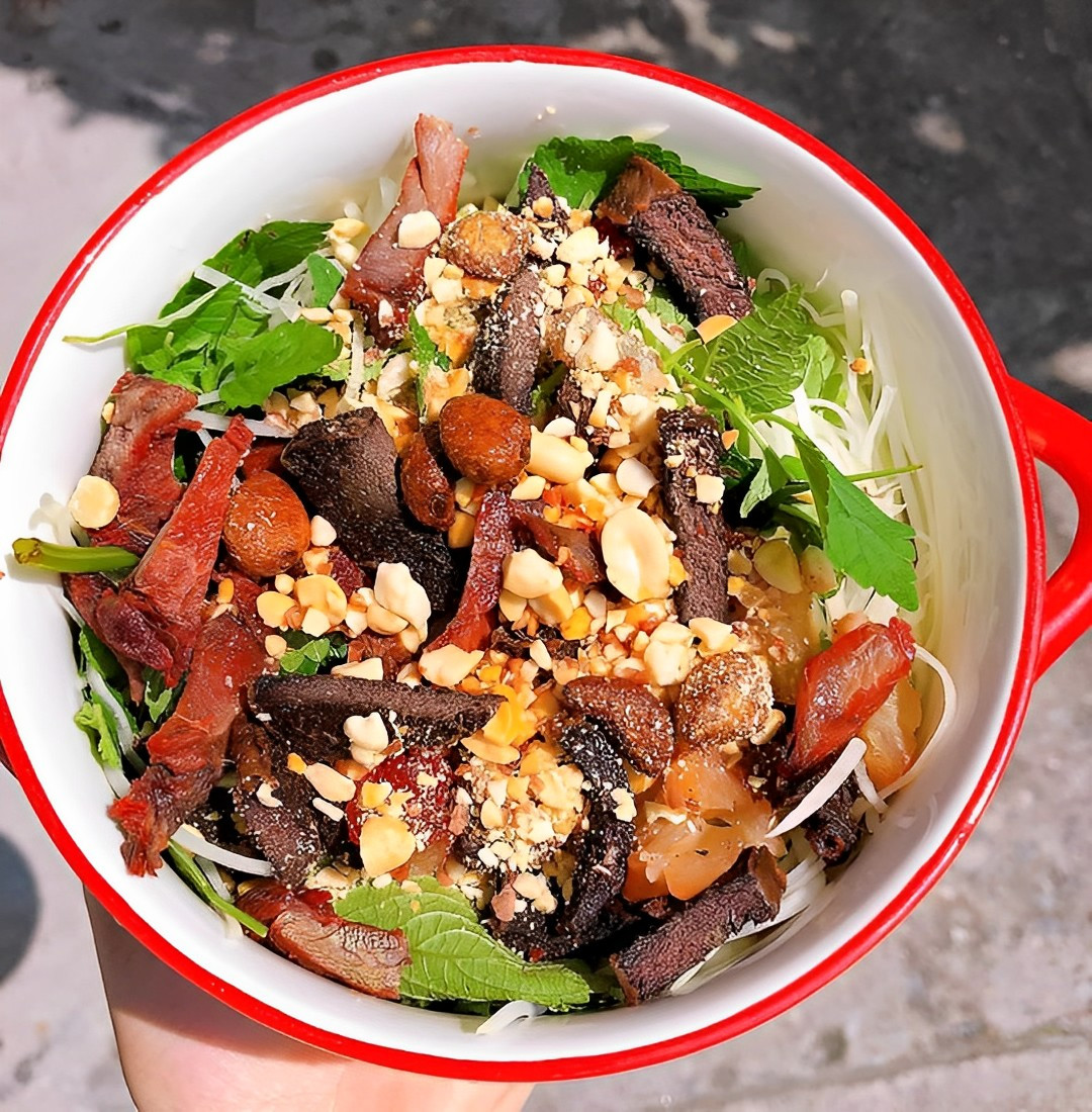 Món ăn vặt nổi tiếng ở phố cổ Hà Nội, nộm bò khô với đu đủ xanh giòn, bò khô dai ngon, lạc rang và nước trộn chua cay mặn ngọt không chỉ kích thích vị giác mà còn giúp cơ thể “hạ nhiệt” trong những ngày hè nắng nóng. Ảnh Internet