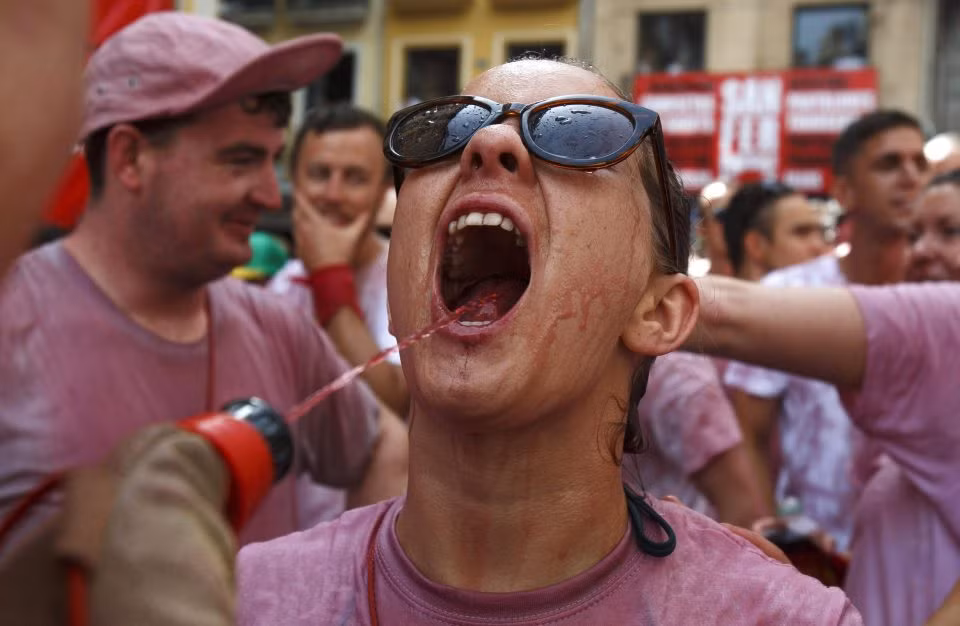 Những người tham gia thích thú bắn rượu vang vào người nhau.