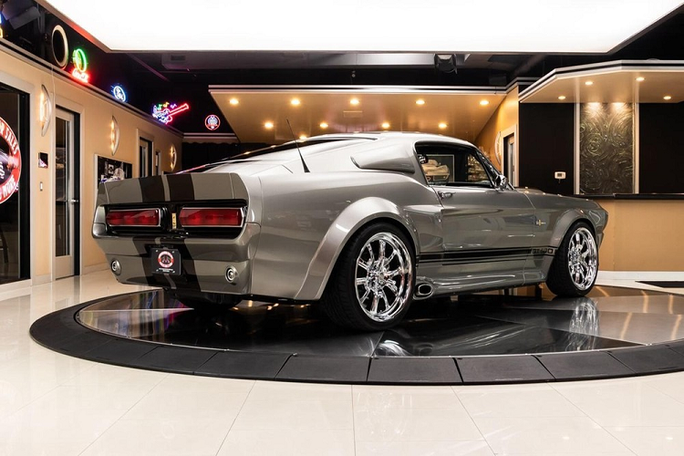 Cụ thể hơn, nó đúng là ra đời trong vai một chiếc Ford Mustang GT Convertible đời 2011 hiện đại nhưng rồi được độ lại toàn diện để trông giống một chiếc Mustang Fastback GT500 cổ điển. Nó là một sự pha trộn hài hòa giữa phong cách bền bỉ với tất cả những trang bị hiện đại mà bạn mong đợi. Bên dưới nắp capô là một khối động cơ V8 Coyote dung tích 5.0 lít, hoạt động phối hợp hộp số tự động 6 cấp. Công suất được truyền tới bánh sau thông qua một hệ thống chống trượt phía sau hoàn thiện với tỉ số 3,31.