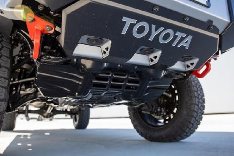 Tiếp đến là ốp cua lốp bằng cao su lớn hơn và cản va hầm hố hơn, được tích hợp cả dải đèn LED. Bậc cửa mới, tấm ốp bảo vệ gầm trước/sau, tấm chắn bùn và móc kéo màu đỏ cũng là những chi tiết đáng chú ý trên Toyota Hilux Mako 2021.