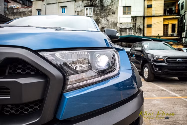 Thay đổi lớn nhất ở phần đầu xe Ford Ranger Raptor 2020 là cụm đèn pha thiết kế vuông vức thay vì bóng tròn như trước. Hơn nữa, cụm đèn này không còn sử dụng công nghệ HID như trước mà thay vào đó là dạng Full-Led. Đây là nâng cấp đáng kể nhất ở ngoại thất trên Ford Ranger Raptor. Trong khi đó, lưới tản nhiệt vẫn đặc trưng với dòng chữ Ford sơn đen thể thao giống F-150.