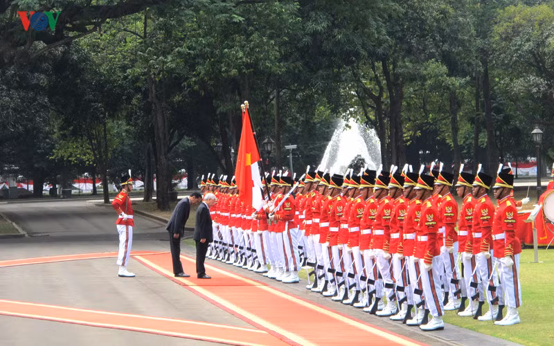 Tổng Bí thư Nguyễn Phú Trọng và Tổng thống Joko Widodo cùng cúi chào Quốc kỳ hai nước.