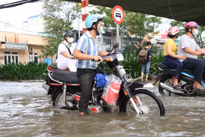Đến 18h cùng ngày, nước trên đường Trần Xuân Soạn vẫn chưa rút, người dân vẫn gặp nhiều khó khăn khi di chuyển.