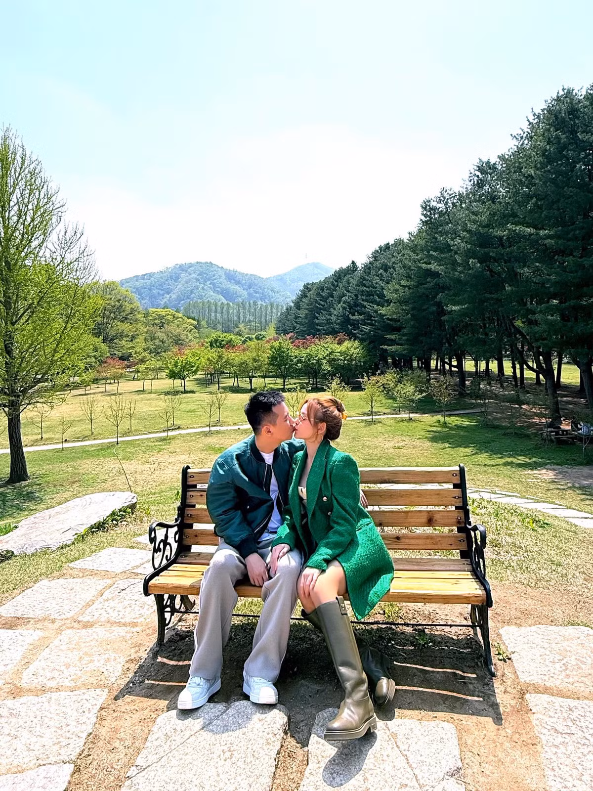 Trên trang cá nhân, Huyền Baby mới đây có màn "phát cơm chó" khiến người theo dõi phải ghen tị. Trong khung cảnh thiên nhiên xanh mát với hàng cây thông thẳng tắp và dãy núi phía xa, cặp đôi ngồi bên nhau trên chiếc ghế gỗ mộc mạc và trao nhau một nụ hôn lãng mạn như phim Hàn. Cả hai diện outfit tông xanh ton-sur-ton cực ăn ý, toát lên vẻ đồng điệu và tinh tế – một vibe vừa thời thượng, vừa dịu dàng giữa khung cảnh thanh bình.