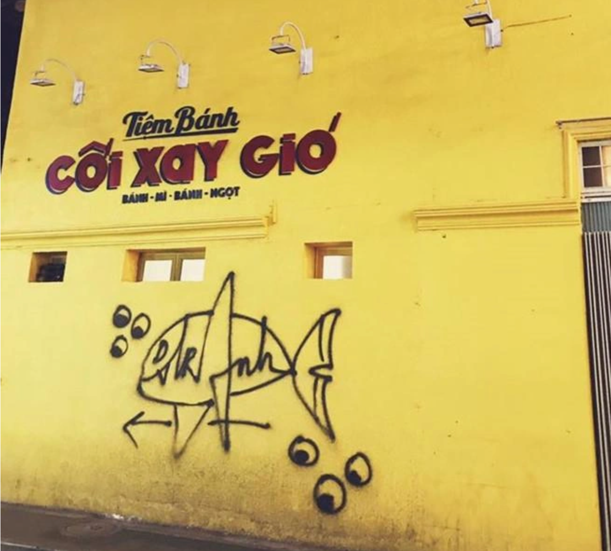 Bức tường vàng tiệm bánh Cối xay gió nổi tiếng tại Đà Lạt bị vẽ bậy hình cá khổng lồ khiến nhiều người không khỏi bức xúc. Ảnh: Demi Vu