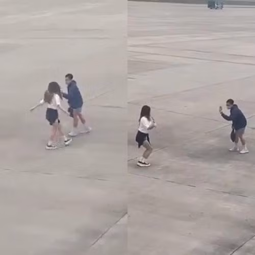 Hai bạn trẻ thản nhiên quay clip tại sân đỗ máy bay.