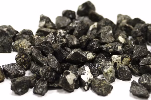 Sau đó, các tinh thể Corundum chứa Carmeltazite được vận chuyển qua các lỗ thông núi lửa vào lớp vỏ trên của Trái Đất. 65 triệu năm trước núi lửa đã phun trào dung nham và luồng hơi nước tràn ngập lớp vỏ trên, tạo ra các lớp trầm tích dày của dăm kết núi lửa và tuff.