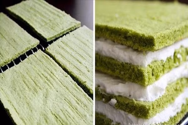 Chia bánh đã nướng làm 4 phần, phết kem topping đã đánh bông vào lần lượt theo thứ tự. 1 phần bánh 1 phần kem, lặp lại đến khi hết đế bánh thì dừng. Phủ đều bột trà xanh lên trên mặt kem để trang trí. Để bánh trong tủ lạnh khoảng 4 tiếng rồi thưởng thức sẽ càng thêm ngon. (Ảnh:thegioibanh.com)