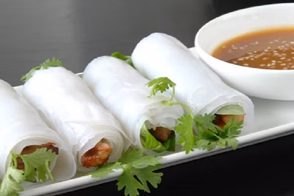 Nếu là tín đồ của món thịt nướng, bạn có thể thưởng thức món bánh ướt cuốn thịt nướng đặc biệt này. Ăn kèm với mè, rau mùi và nước nắm đậu phụng. Bánh cuốn nhân thịt nướng rất phổ biến tại các nhà hàng, quán ăn tại Huế. (Ảnh:m.sim.name.vn)