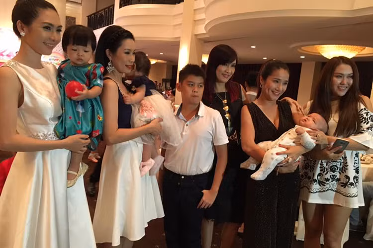 Đến tham gia tiệc mừng con gái Trịnh Kim Chi, Phi Thanh Vân (ngoài cùng bên phải) dẫn theo cậu con trai Tấn Đức. Trong ảnh, bé ngoan ngoãn nằm trên tay diễn viên Cát Tường (thứ hai từ phải sang).