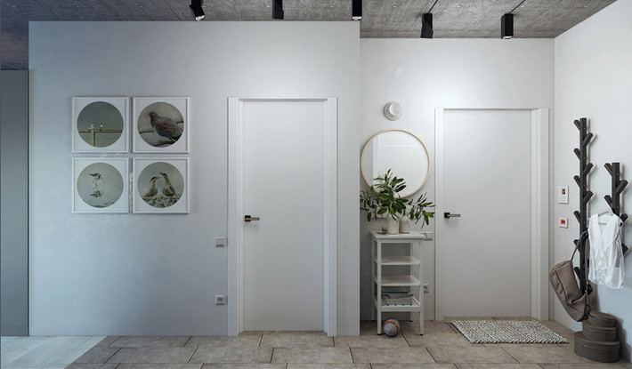 Gương tròn treo tường biến bức tường thành điểm nhấn đậm tính nghệ thuật, trong khi phông nền trắng tạo cái nhìn độc đáo cho giá treo quần áo.