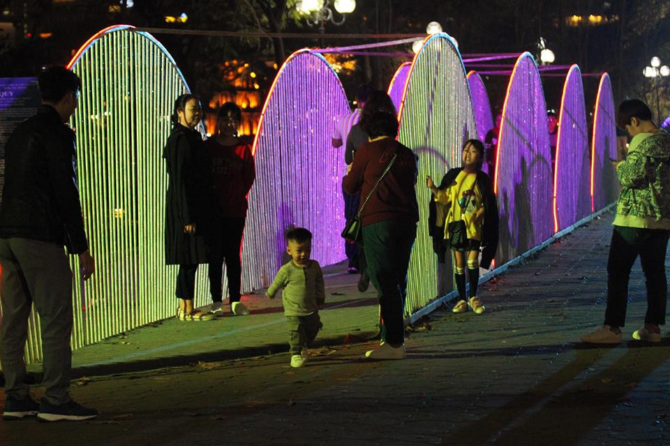 Trong lúc chờ đợi, nhiều người tranh thủ chụp ảnh tại các khuôn viên trang trí Tết.