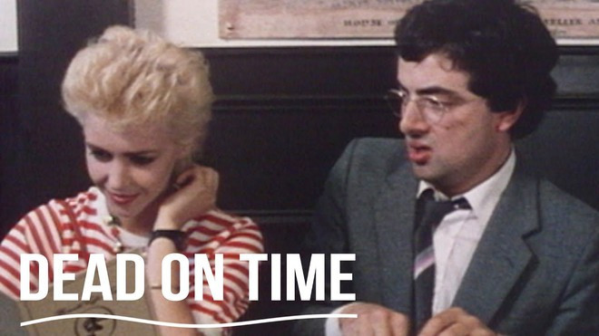 Năm 1983, Rowan Atkinson có bộ phim điện ảnh đầu tiên khi đóng một vai phụ trong một phim về điệp viên James Bond là Never Say Never Again. Cùng năm đó, ông đóng vai chính trong phim ngắn Dead on Time, kể về người đàn ông vội vã đi tìm tình yêu đích thực sau khi được chẩn đoán là mắc chứng bệnh lạ.