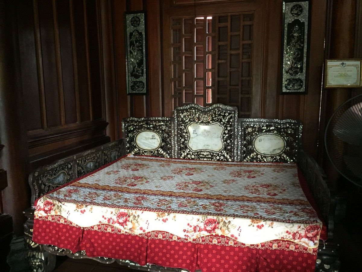 Hai gian hai bên hông của ngôi nhà ông Hạ đều kê một bộ bàn ghế làm bằng gỗ gụ để tiện cho việc đón, tiếp khách. “Ngôi nhà được thiết kế theo kiến trúc cổ nên gia đình rất ưng và thích. Ở trong ngôi nhà này mùa hè thoáng mát, còn mùa đông lại ấm”, ông Hạ nói. Chiếc giường ngủ cũng được gia chủ đặt, thiết kế đóng theo lối cổ kính. Theo chủ nhân của ngôi nhà, mất hơn nửa năm tốp thợ hơn chục người mới thi công, lắp ghép xong ngôi nhà.